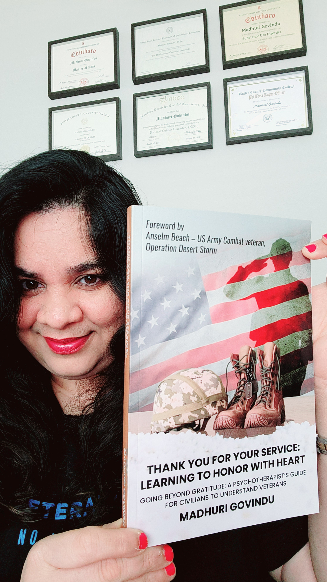 Madhuri Govindu, LPC holding her award-winning book Thank You for Your Service
